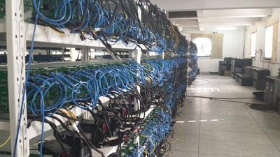 An expansive cryptocurrency mining farm with rows of ASIC miners
